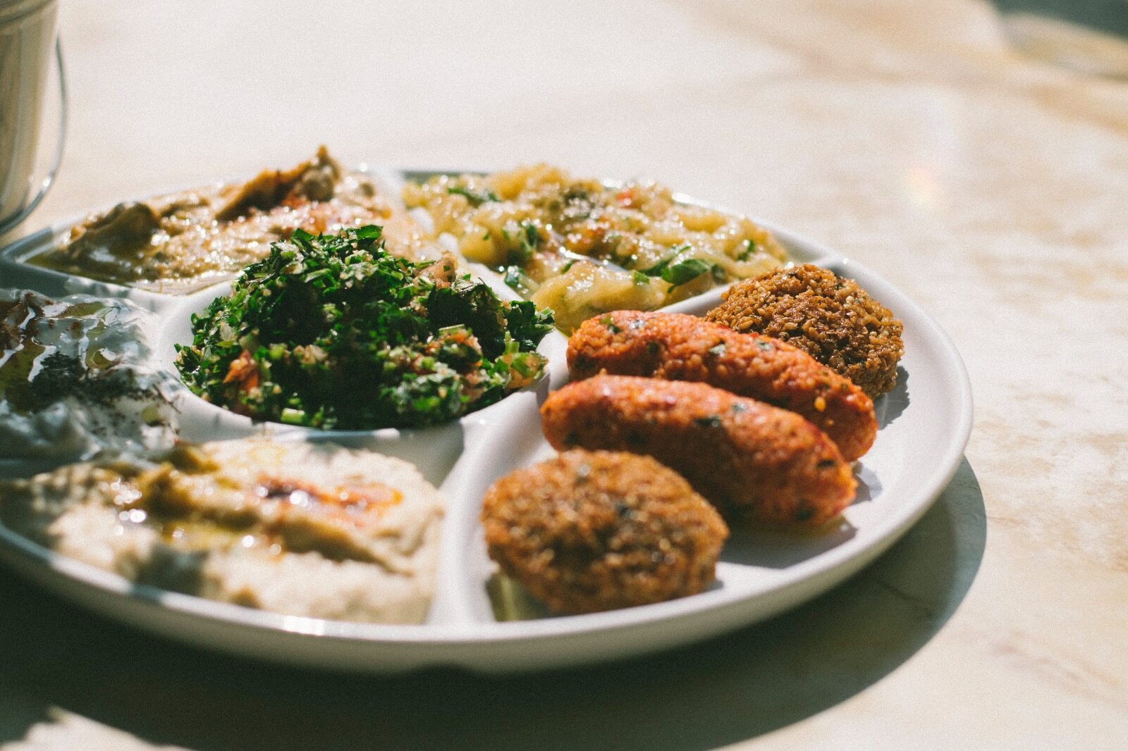 Bord met falafel, kibbeh, tabouleh, hummus en baba ganoush